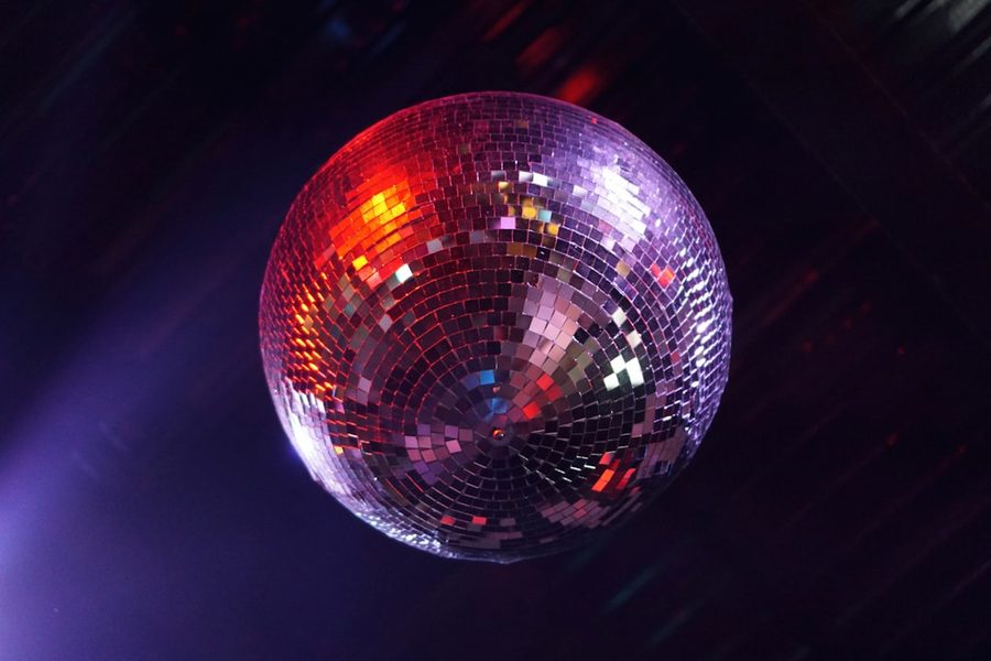 Disco ball spinning in pink and purple light